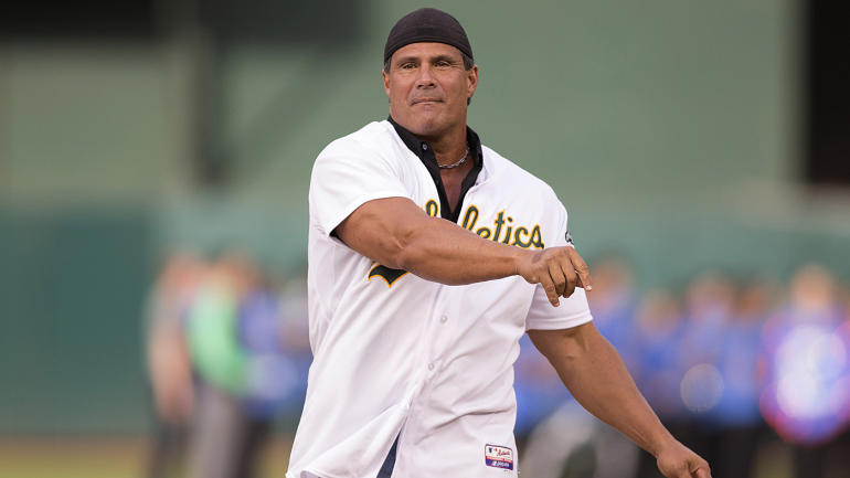 Jose Canseco Throwing in an Athletics Jersey