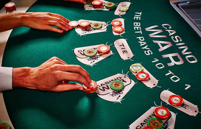 How are ties resolved in Casino War?