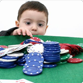 Little kid grabbing poker chips off table