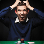 Man grabbing his hair in frustration in poker game