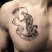 Skeleton hand holding cards tattoo