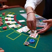 Casino dealer dealing blackjack cards