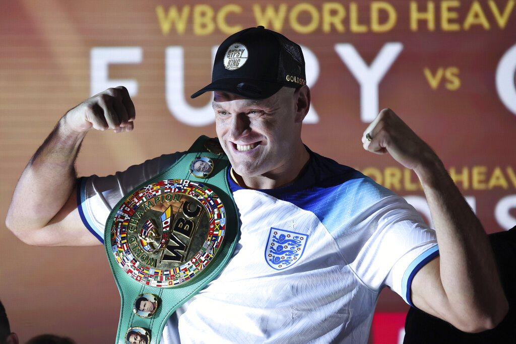 Tyson Fury flexing his muscles at a boxing promotion