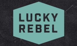 Teal Lucky Rebel logo with on dark background