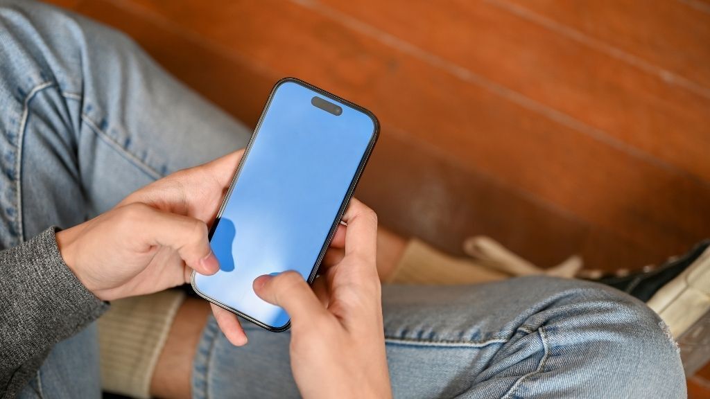 someone using a phone seated