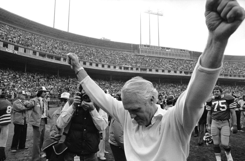 San Francisco 49ers head coach Bill Walsh holds his arms in the air in victory