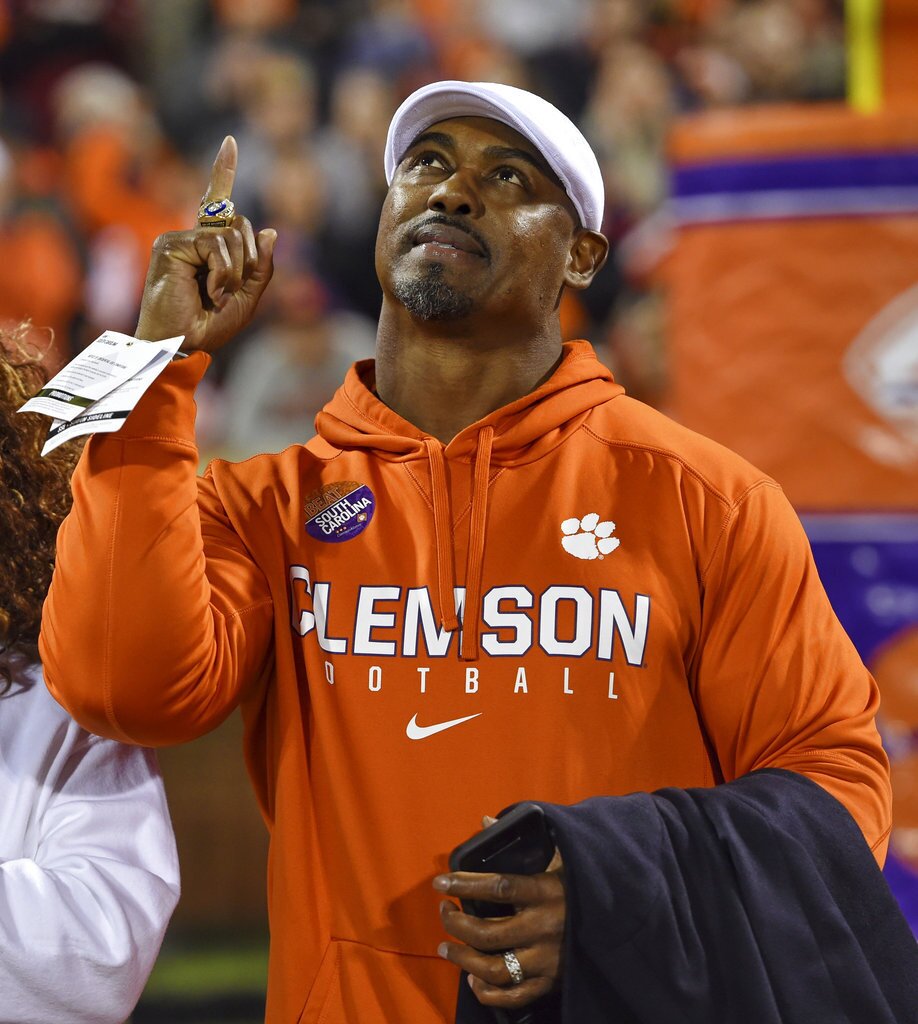 Former Clemson and NFL player Brian Dawkins points upward