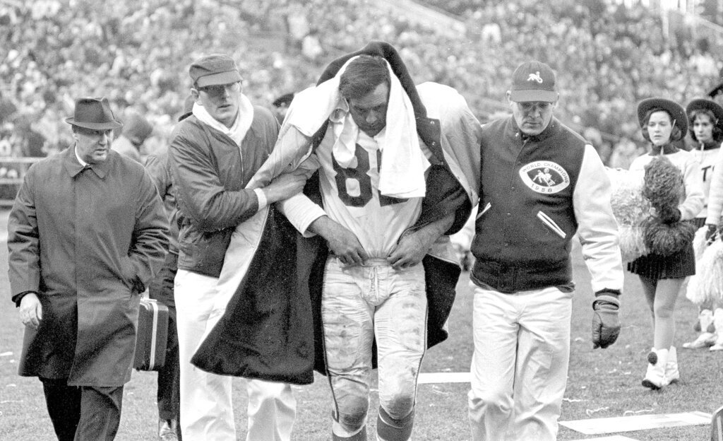 Gino Marchetti is helped off he field