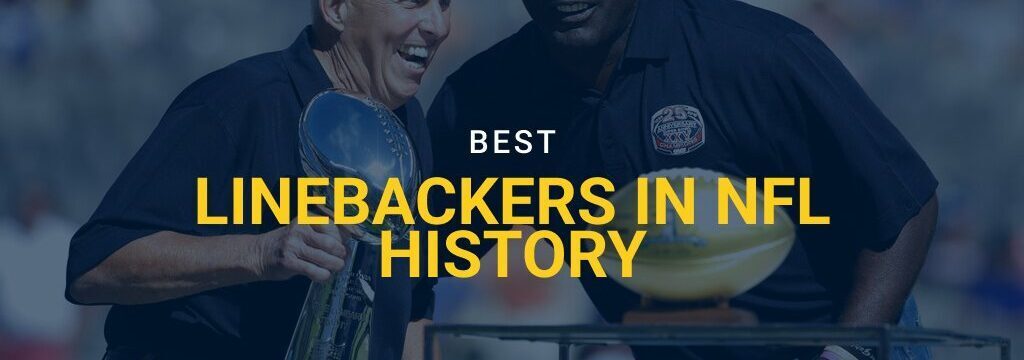 Former New York Giants head coach Bill Parcells, left, holds the Super Bowl XXV trophy while joining former linebacker Lawrence Taylor on stage