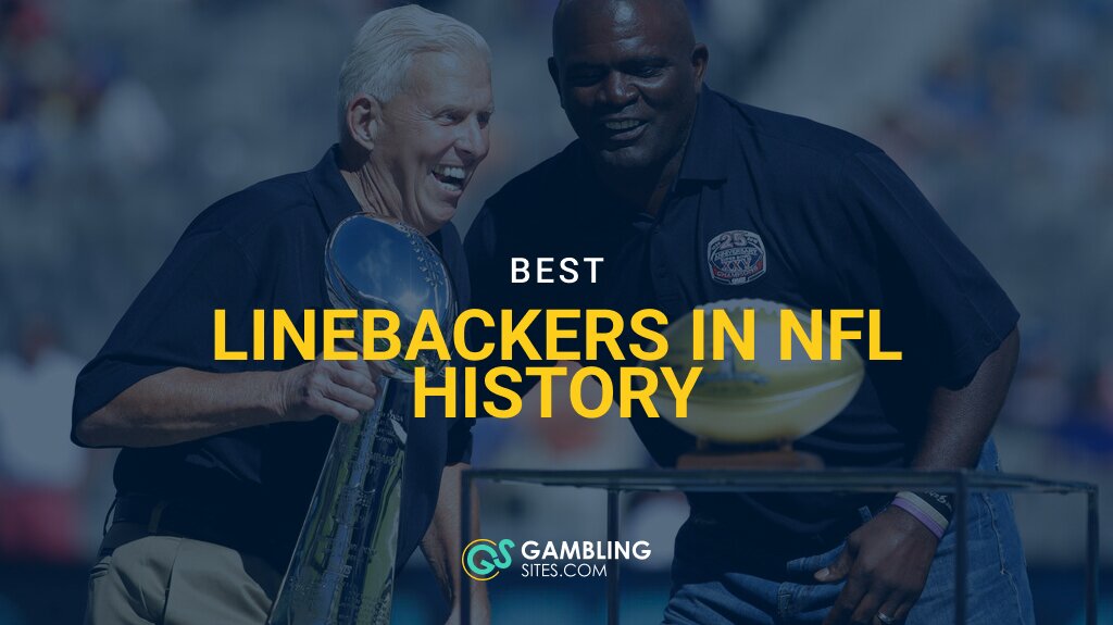 Former New York Giants head coach Bill Parcells, left, holds the Super Bowl XXV trophy while joining former linebacker Lawrence Taylor on stage