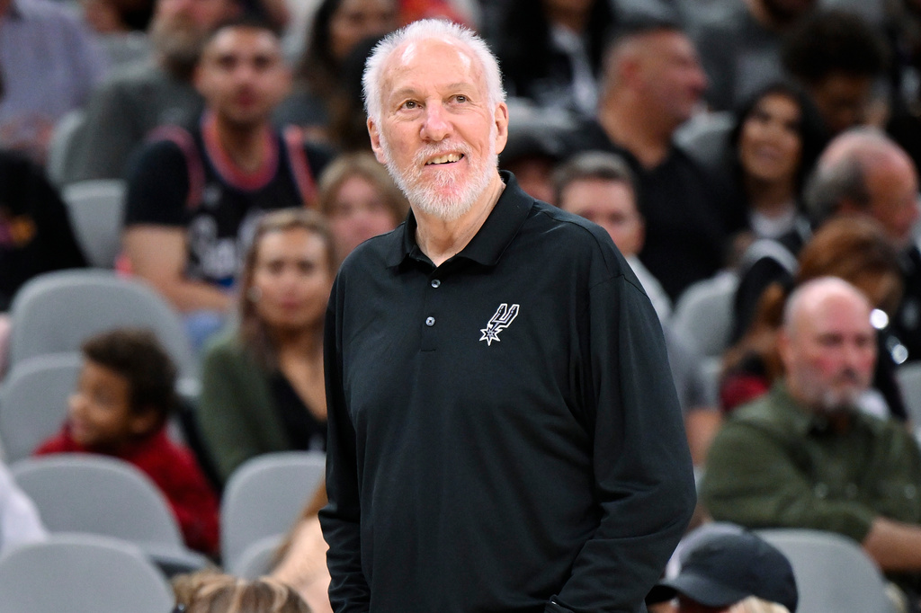 NBA coach Gregg Popovich standing on the sidelines during a game