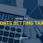 Calculator saying taxes with graphs on paper