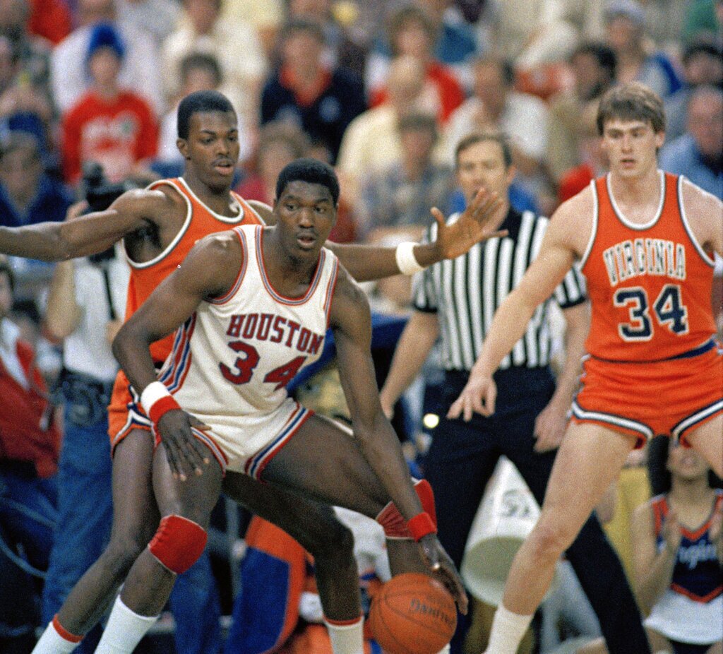 Houston's Hakeem Olajuwon dribbles around the defense of Virginia's Kenton Edelin