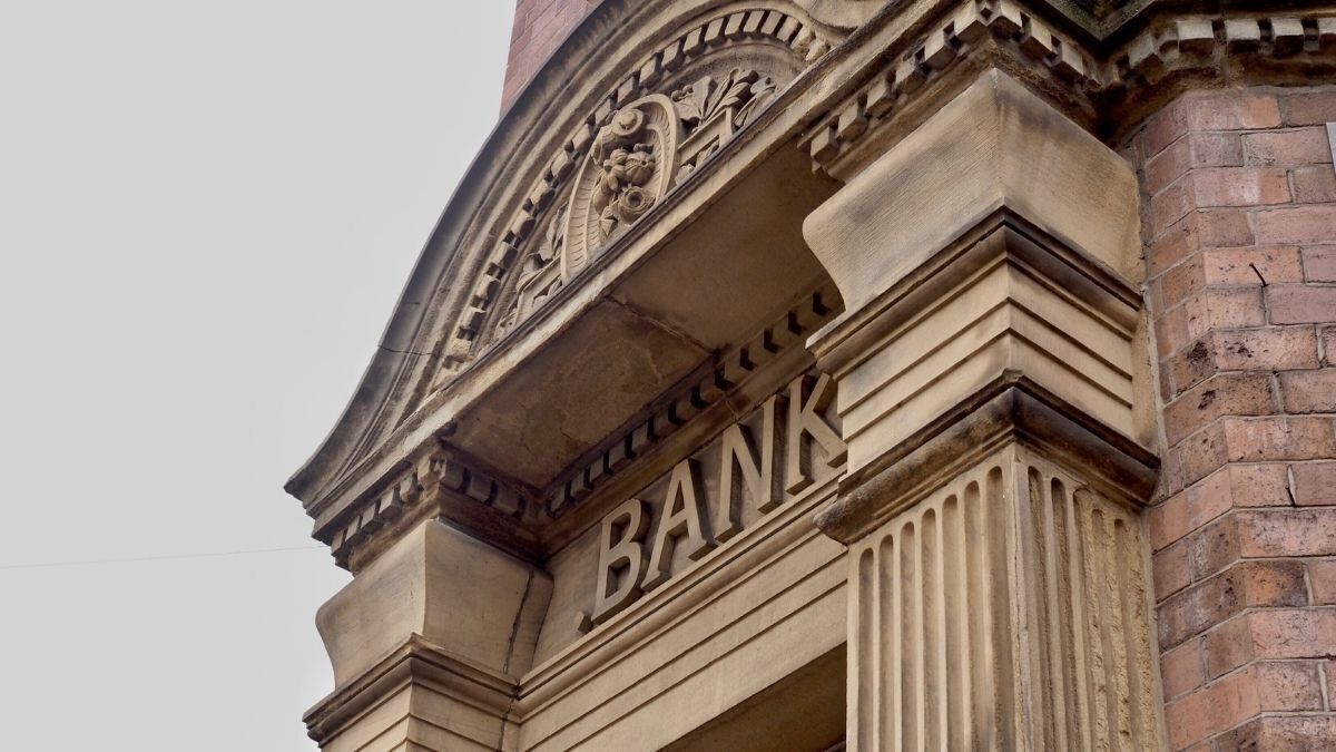 Exterior of an old stone bank building with carved architectural details