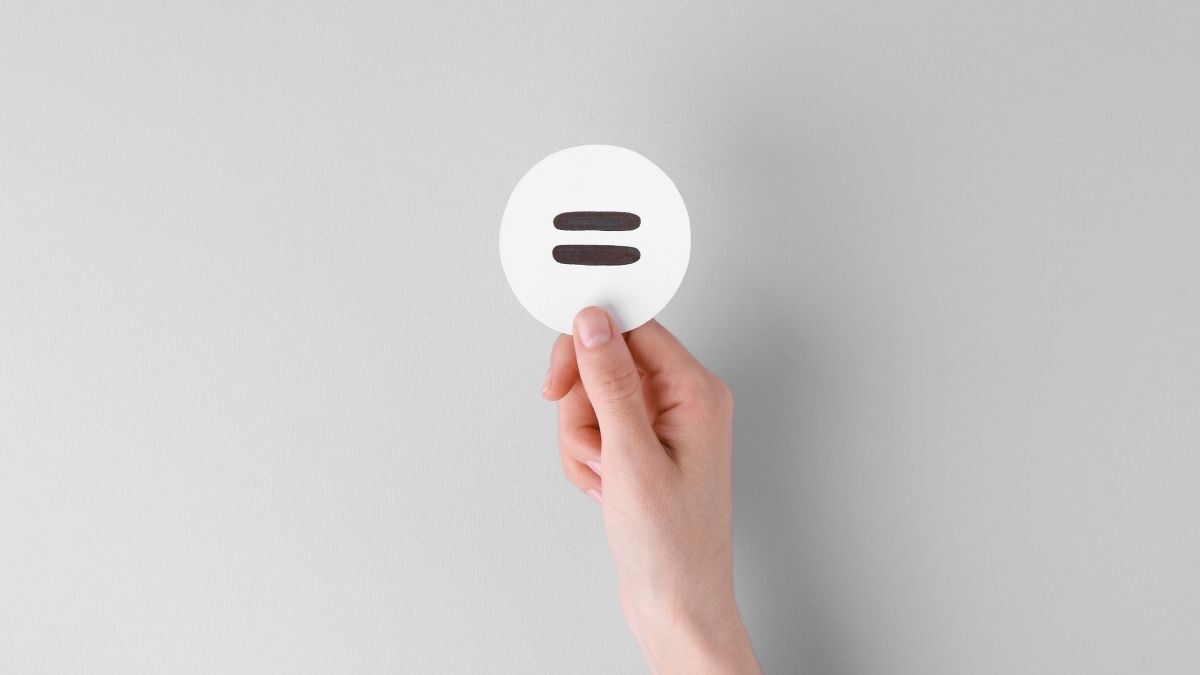 Hand holding a white circle with an equals sign symbol