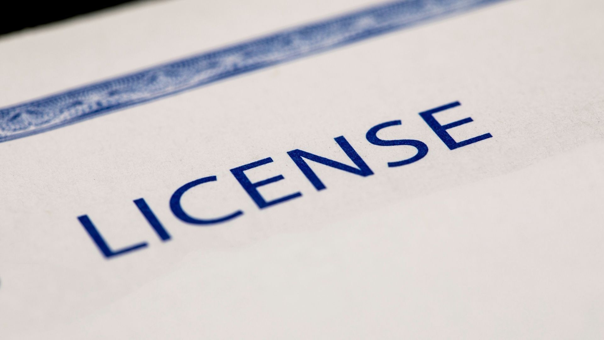 Stock image of a licence document with official seal and pen