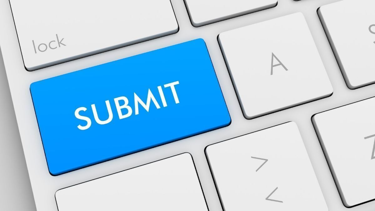 A close-up of a computer keyboard featuring a bright blue key labeled “SUBMIT” next to standard white keys
