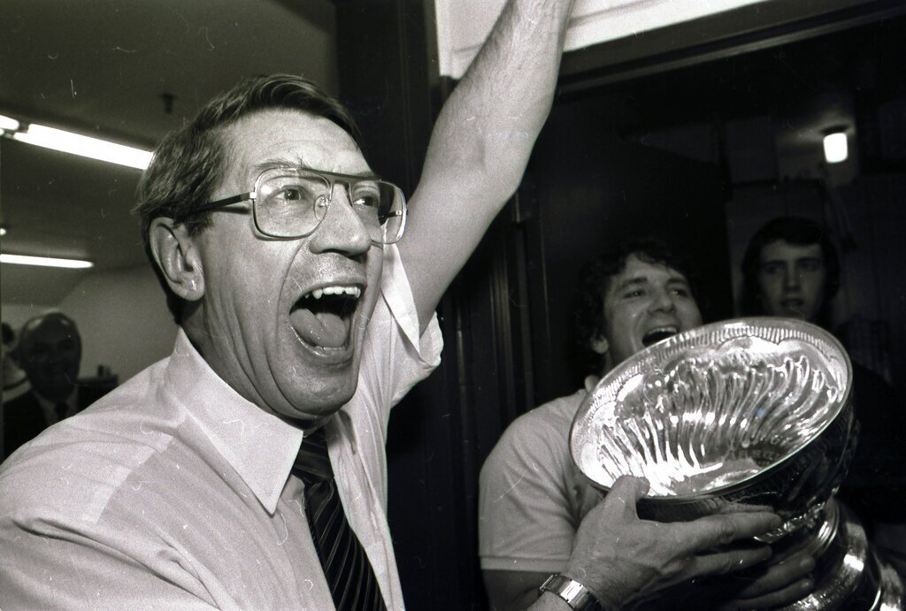 New York Islanders coach Al Arbour celebrates in the locker room