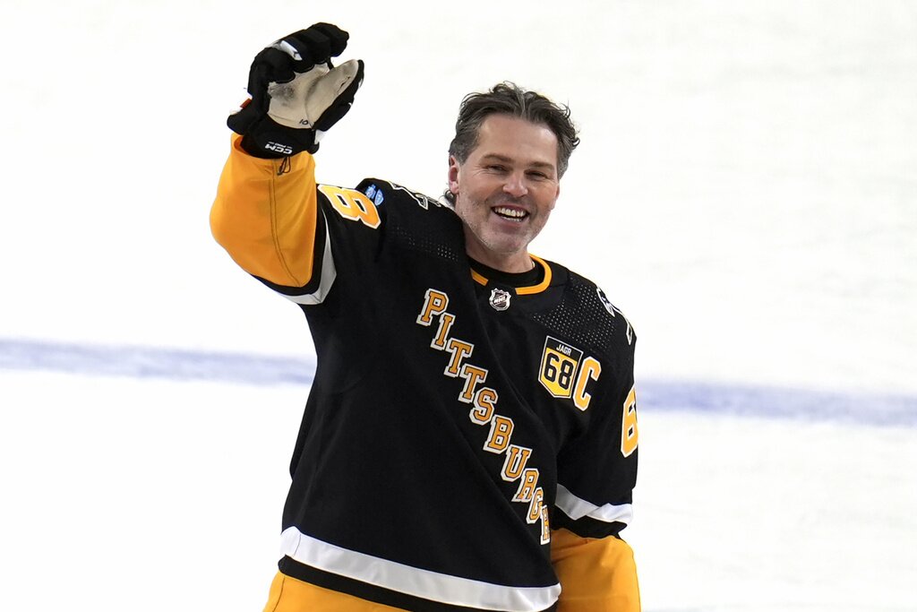Former Pittsburgh Penguins player Jaromir Jagr stands at center ice