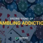 Playing cards and casino chips scattered on a table with text overlay “Seeing Signs of Gambling Addiction” and GamblingSites.com branding