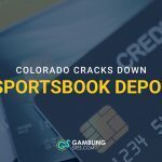Credit cards in the background with text reading “Colorado cracks down on sportsbook deposits.”