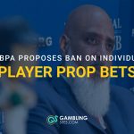 Man at a press conference with text reading “MLBPA proposes ban on individual player prop bets.”