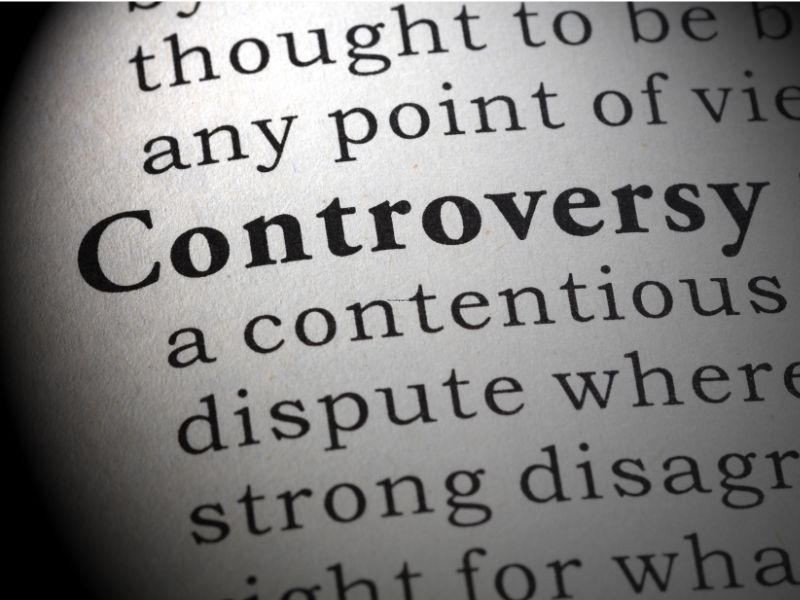 Close-up of the word “Controversy” and its dictionary definition.