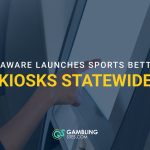 Person using a self-service kiosk with text reading “Delaware Launches Sports Betting Kiosks Statewide.”
