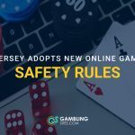 Casino chips, dice, and playing cards on a laptop with text reading “New Jersey Adopts New Online Gambling Safety Rules.”