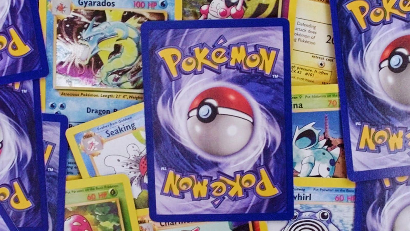 Overlapping Pokémon trading cards showing card backs and characters including Gyarados, Seaking, and Poliwhirl.